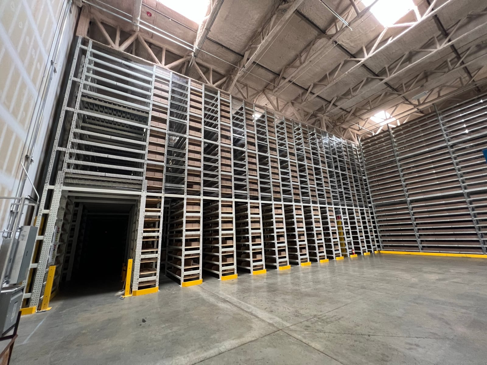 Bank of multi-tier tube rack file storage shelving reaching toward the roof deck of a Redlands, CA records facility